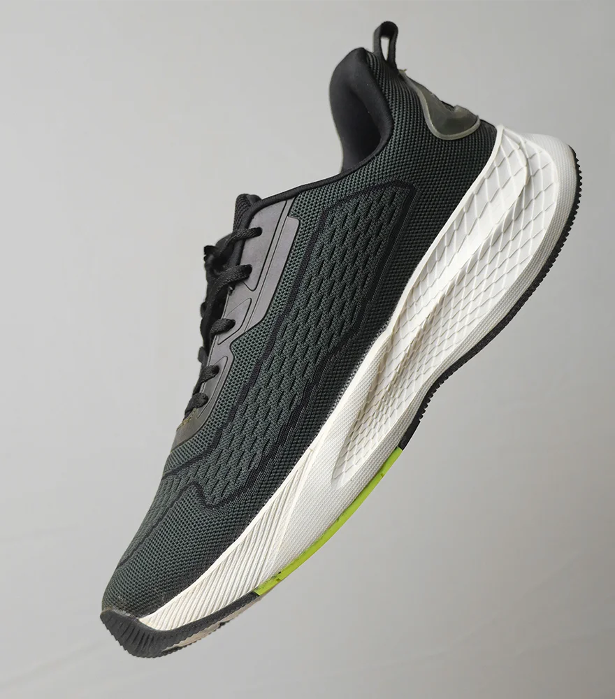 Original photo of a black sneaker on a gray background with shadows.