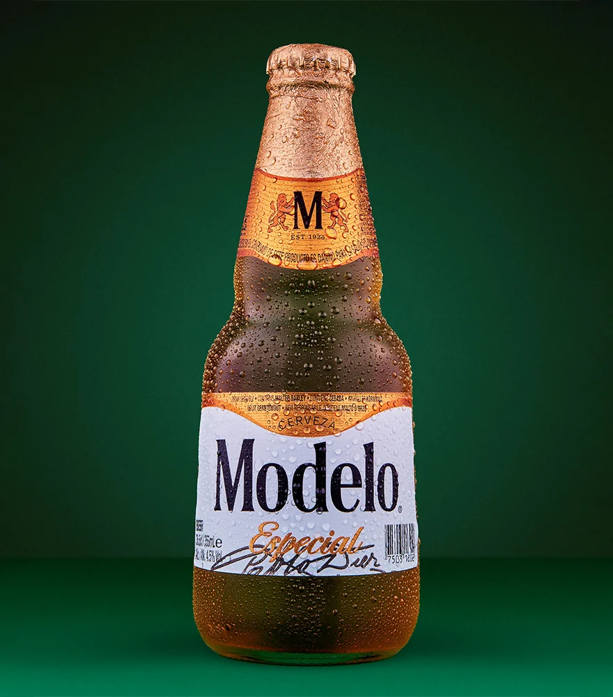 Original beer bottle photo with green background before editing.