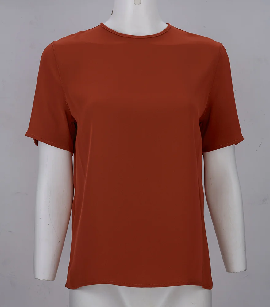 Rust-colored t-shirt displayed on a mannequin torso before ghost mannequin removal.