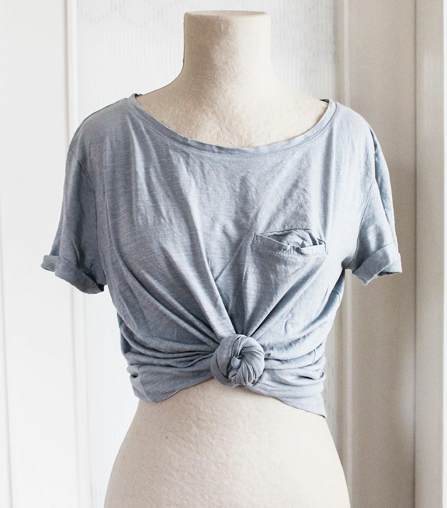 Crop top displayed on a beige mannequin torso before image editing.