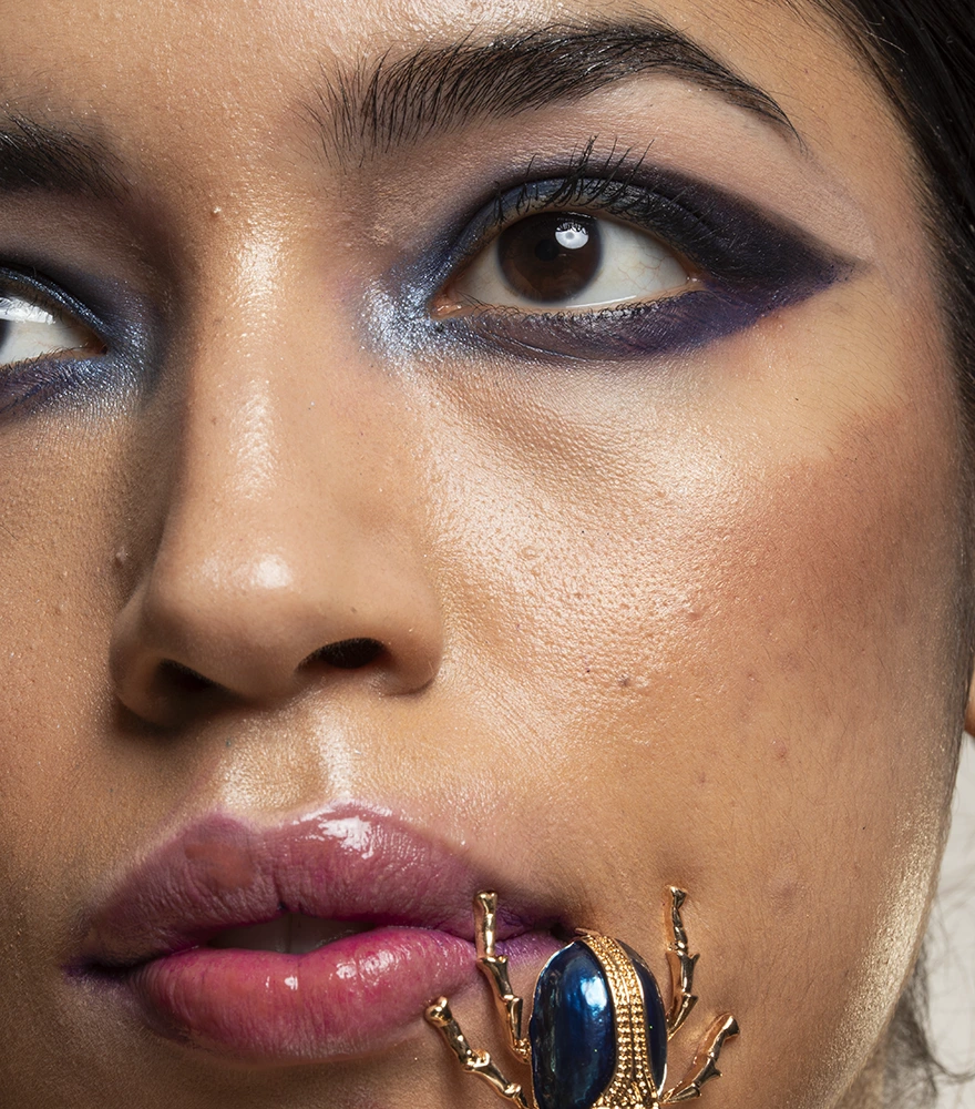 Unedited close-up of a woman’s face showing uneven makeup and lighting.
