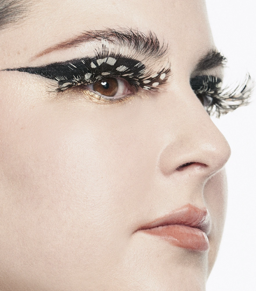 Close-up of a model’s face with smooth skin and artistic makeup after AI skin retouching.