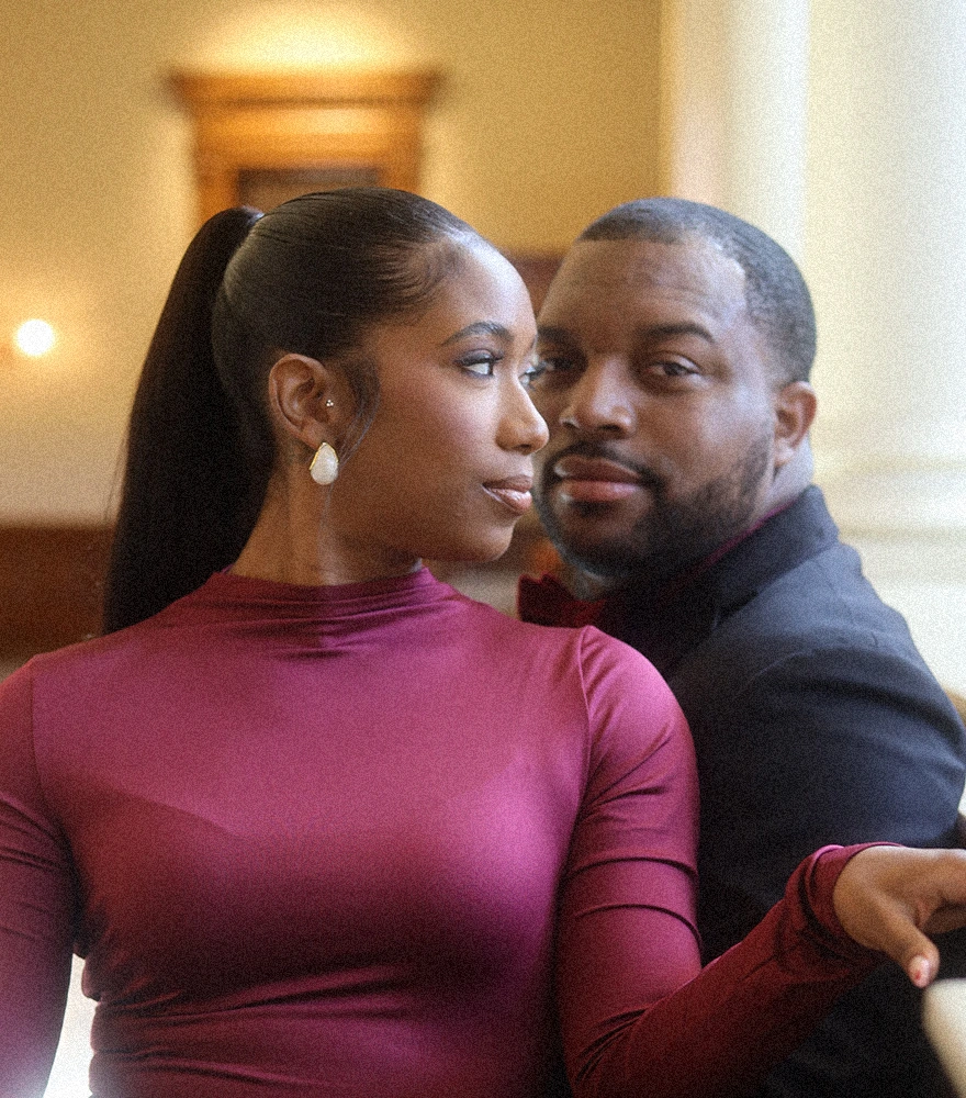 Low-resolution image of a couple in a softly lit indoor setting.