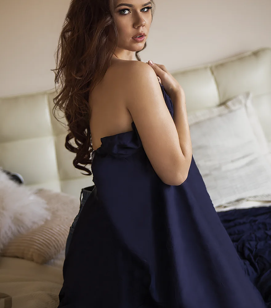 Woman in a navy dress with fabric enhanced for texture and smoothness.