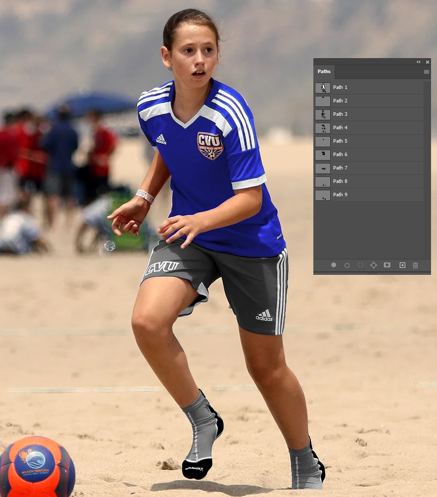 A soccer player fully masked in multiple clipping paths displayed in Photoshop panel.