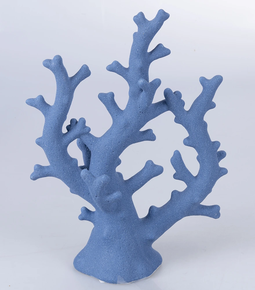 A single coral-shaped decorative item in matte blue on plain light background.