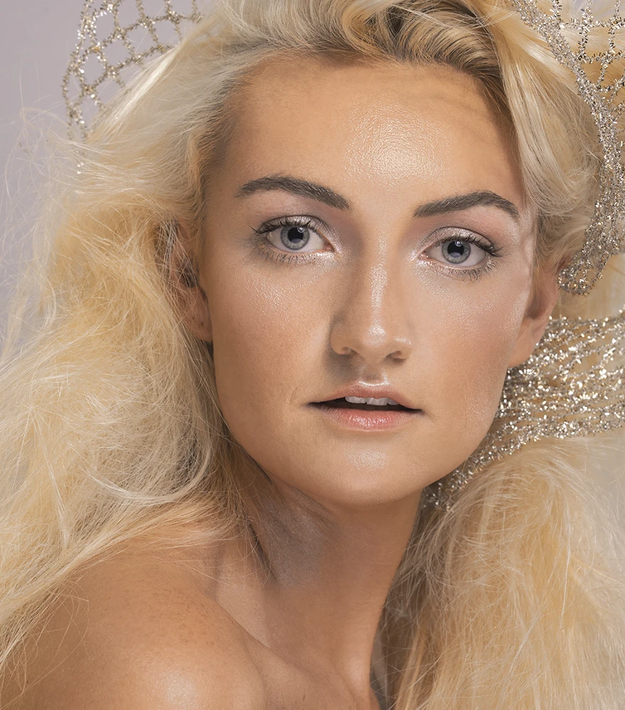 Fashion portrait with corrected skin tone, even highlights and smooth finish.