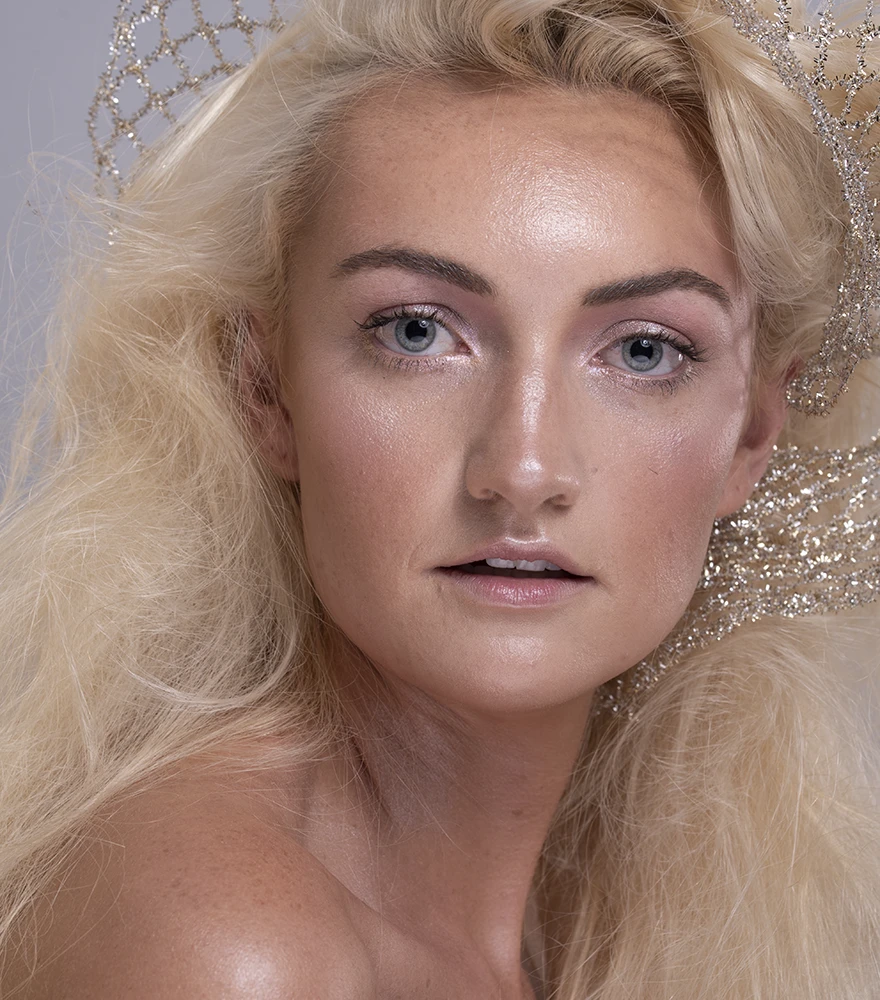 Original beauty portrait with uneven skin tone and slightly washed-out lighting.