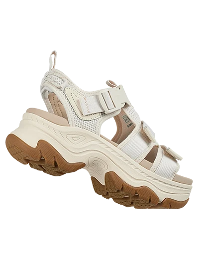 Chunky white sports sandal with textured sole and adjustable straps.