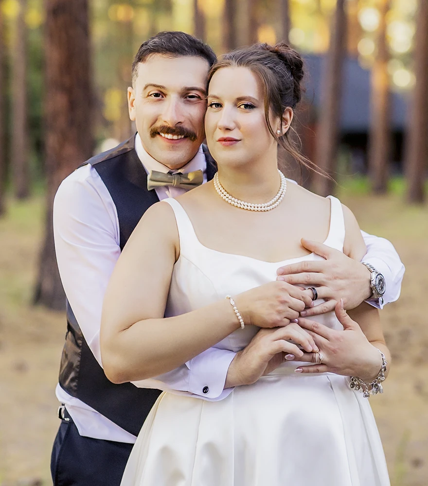 Edited wedding portrait of bride and groom with soft retouching and warm tones.
