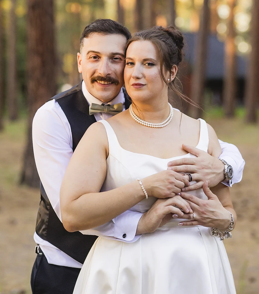 Original wedding photo of couple standing closely in natural light setting.