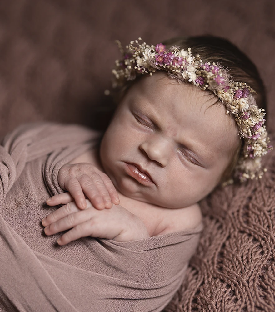 Original newborn photo with unedited background and less contrast.