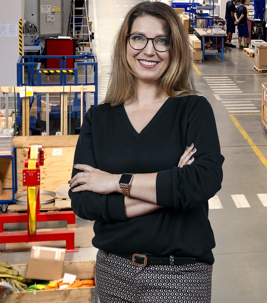 Background Cleanup & Replacement_After Edited portrait of a woman with clean beige studio-style background replacing the busy warehouse.