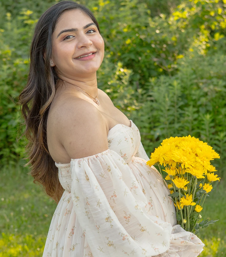 Natural outdoor maternity photo with color imbalance and uneven skin tones.