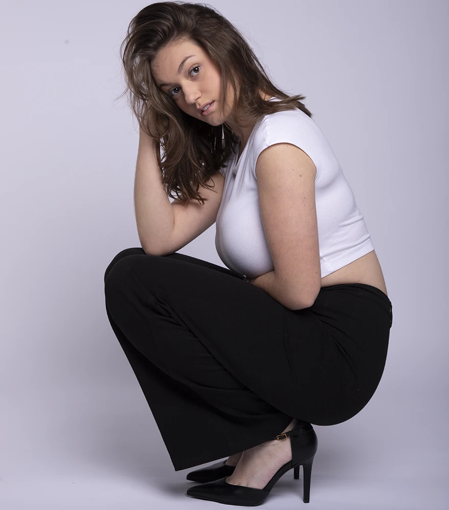 Full-body portrait before retouching with normal lighting and natural details.