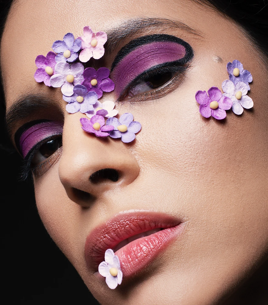 Enhanced beauty portrait featuring smooth skin, vibrant contrast, and vivid makeup.