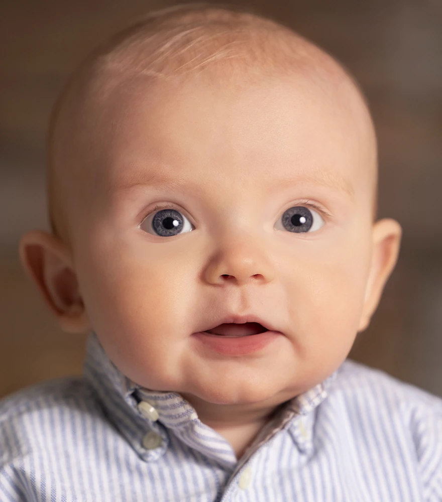 Baby portrait after removing blemishes and smoothing facial skin.