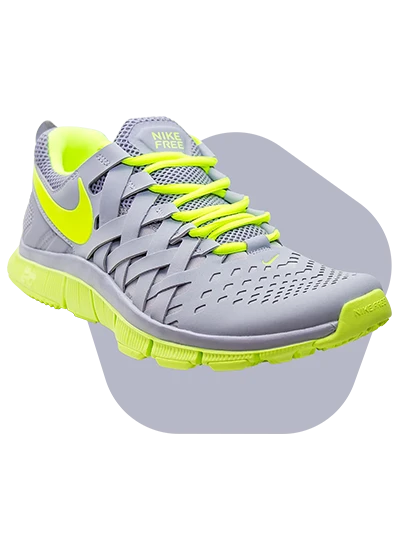 Grey and neon green Nike running shoe with breathable mesh and flexible sole.