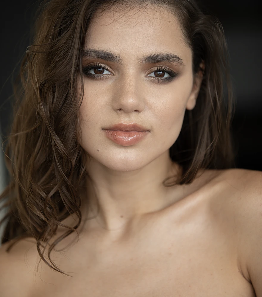 Color Grading & Enhancement_Before Natural-light portrait of woman with flat shadows and lower contrast.