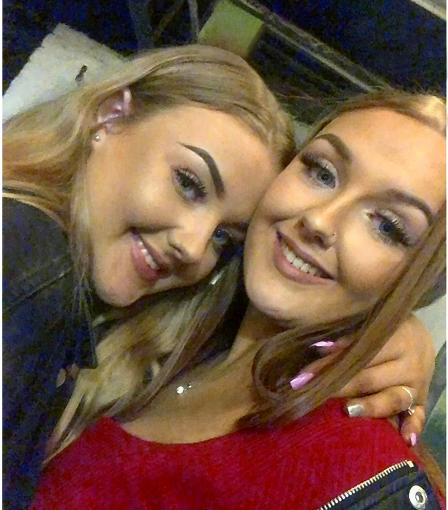 Cleaned and retouched photo of two smiling young women, with dust, scratches, and stains removed.