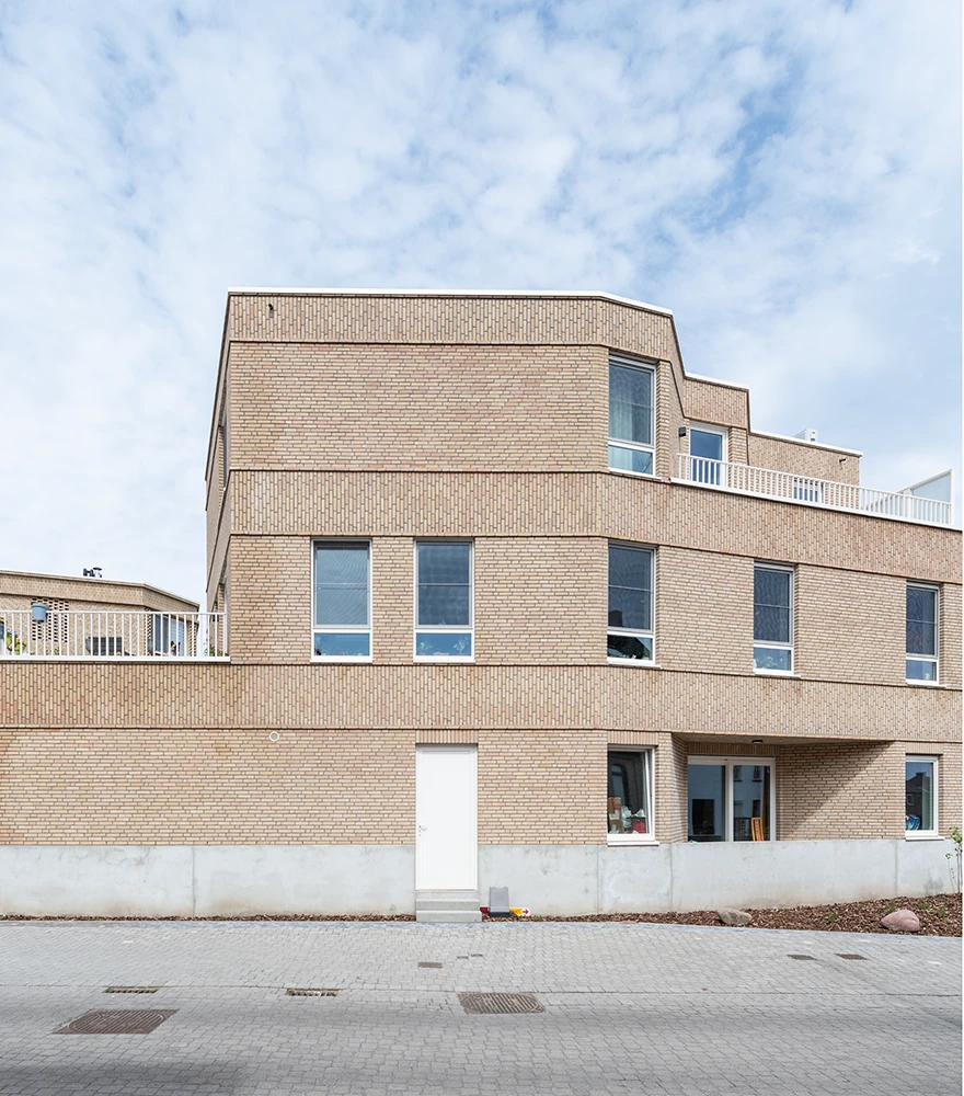 Property exterior with patchy grass and dull lawn appearance.