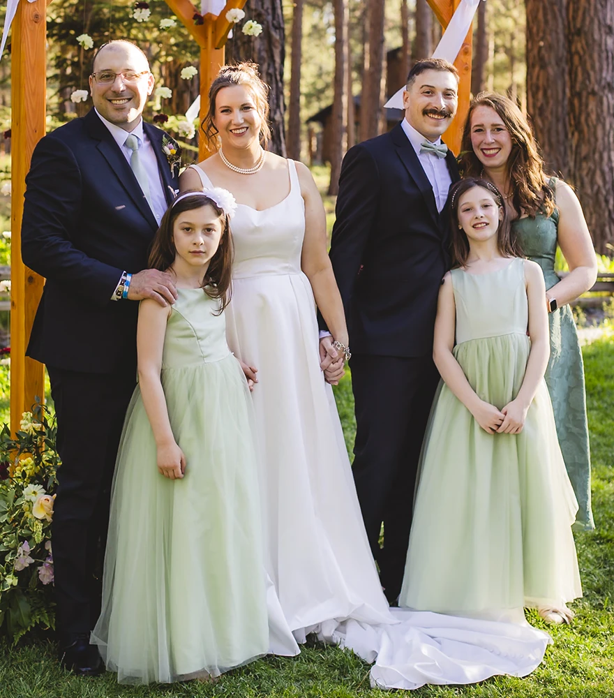 Wedding group photo with child's facial expression corrected through retouching.