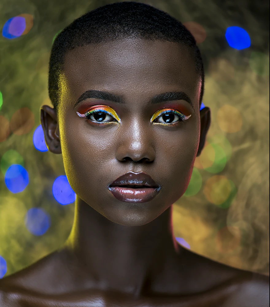 High-end editorial portrait with sharp contrast, deep tones, and flawless skin.
