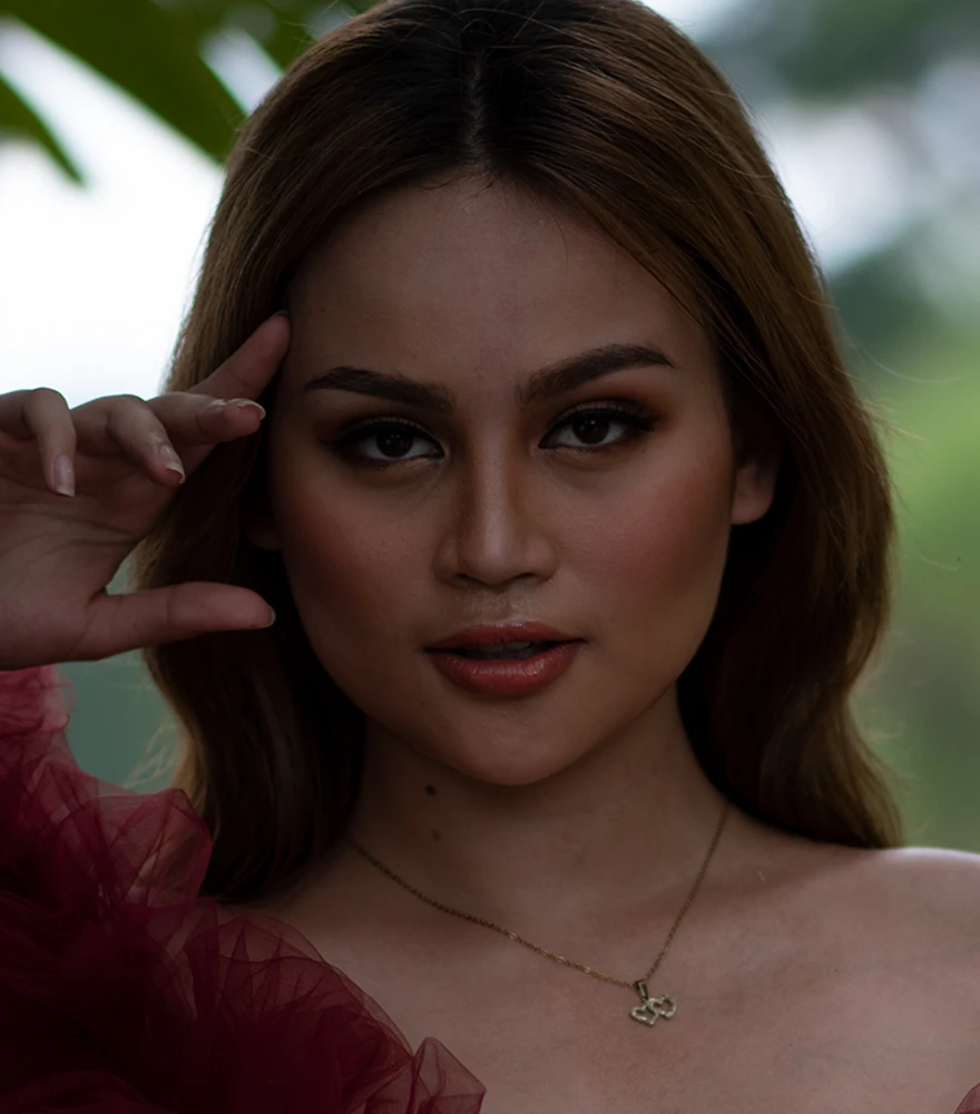 Original unretouched portrait of a woman with dark lighting and visible skin texture.