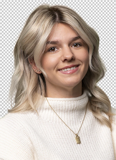 Smiling woman with blonde hair in a loose wave, white sweater, and gold necklace.