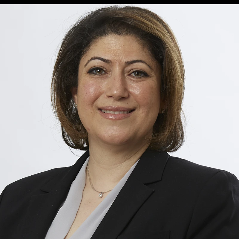 Unedited headshot in studio setup showing visible shadows and minor spots.