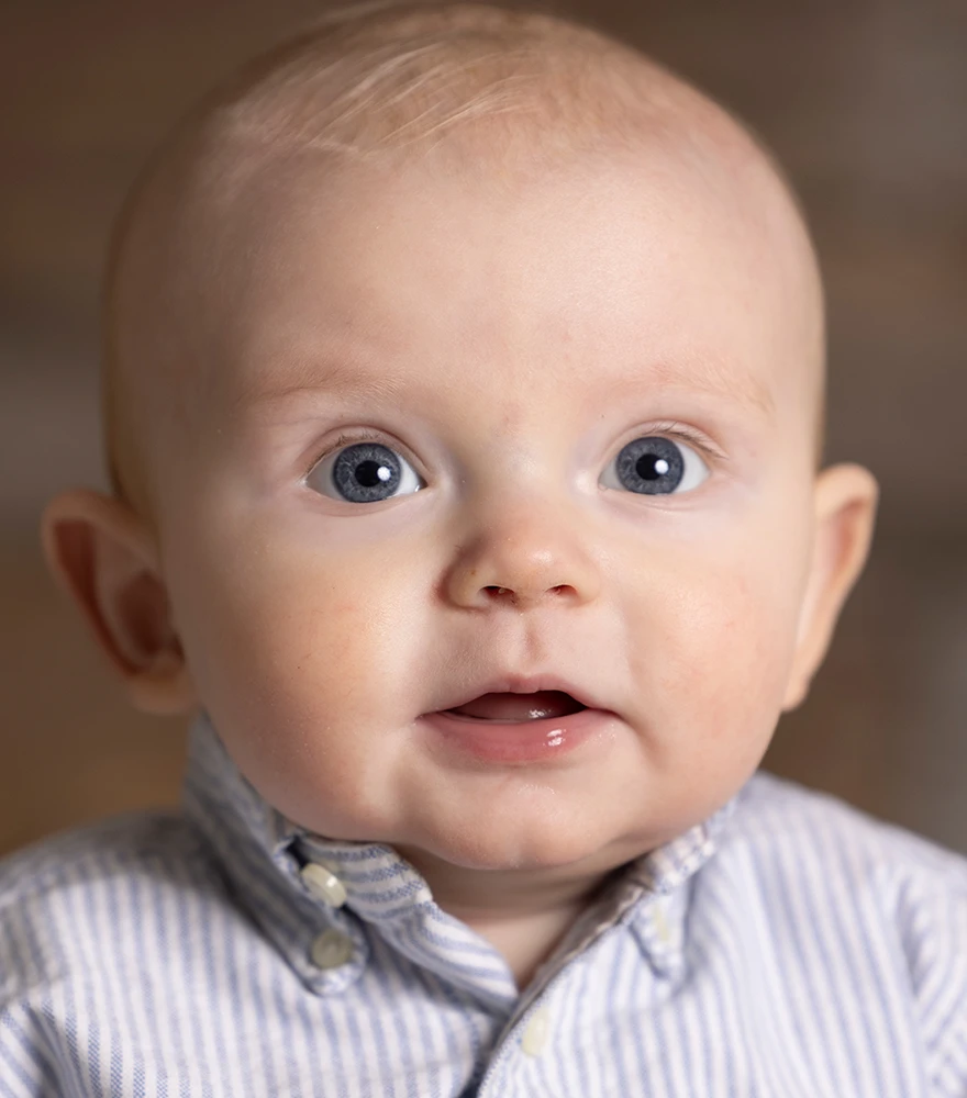 Raw close-up image of a baby with natural lighting and unretouched skin.