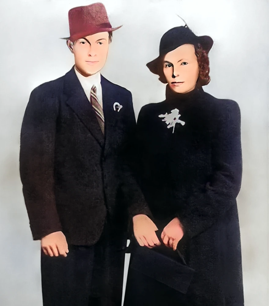 Restored and sharpened image of a man and woman in formal attire with reduced noise and enhanced details.