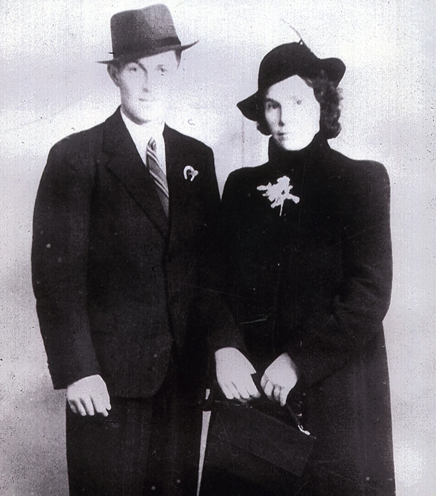 Noise Reduction & Sharpening_Before Old photo of a man and woman in formal wear with visible noise and lack of clarity.