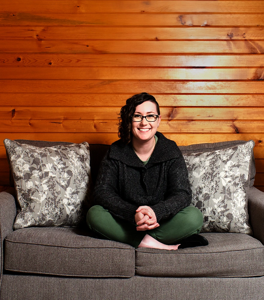 Framed painting Removed to the wooden wall behind the seated woman.