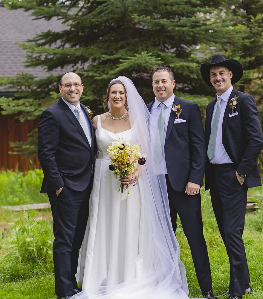 Original wedding portrait with bride, groom, and three men including an extra person.