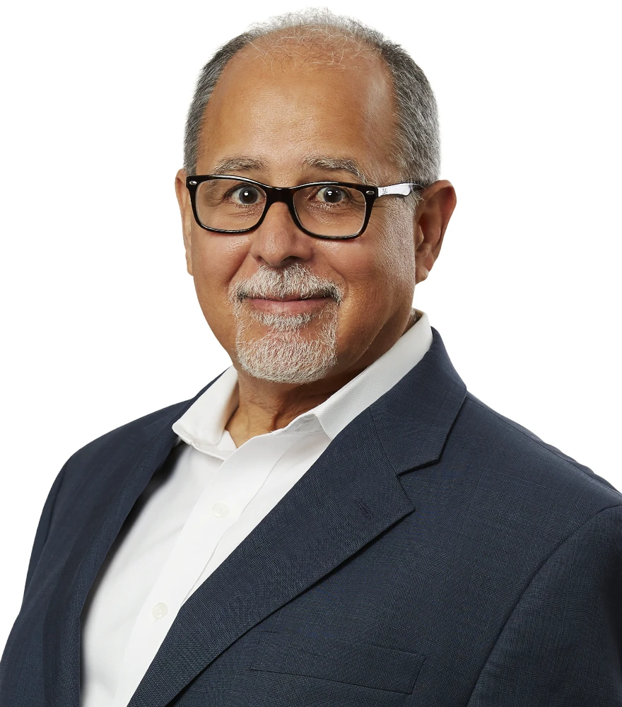 Professional headshot of a man with enhanced contrast, clean background, and polished look.