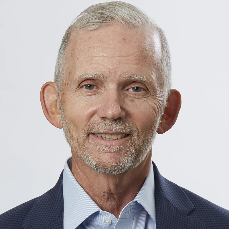 Natural headshot of a mature man in business attire with unaltered details.