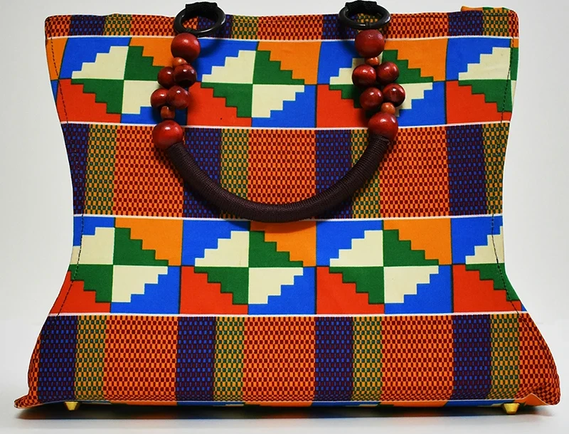 Product Retouching Services_Hero_Before_1 Original product image of a fabric handbag with shadow issues and color imperfections.