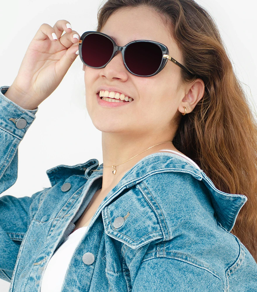 Sunglasses on a smiling woman with glare removed from the lenses.
