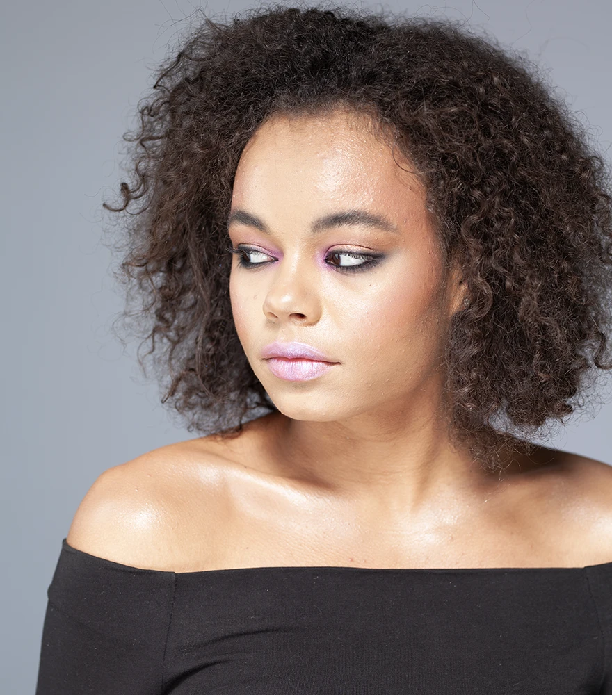 Shadow & Highlight Balancing_Before Portrait of a woman with shiny, oily skin and unbalanced lighting.