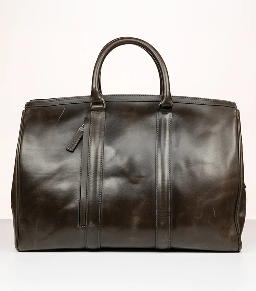 Shape & Symmetry Corrections_Before Unedited photo of a leather handbag with creases and asymmetrical shape imperfections.