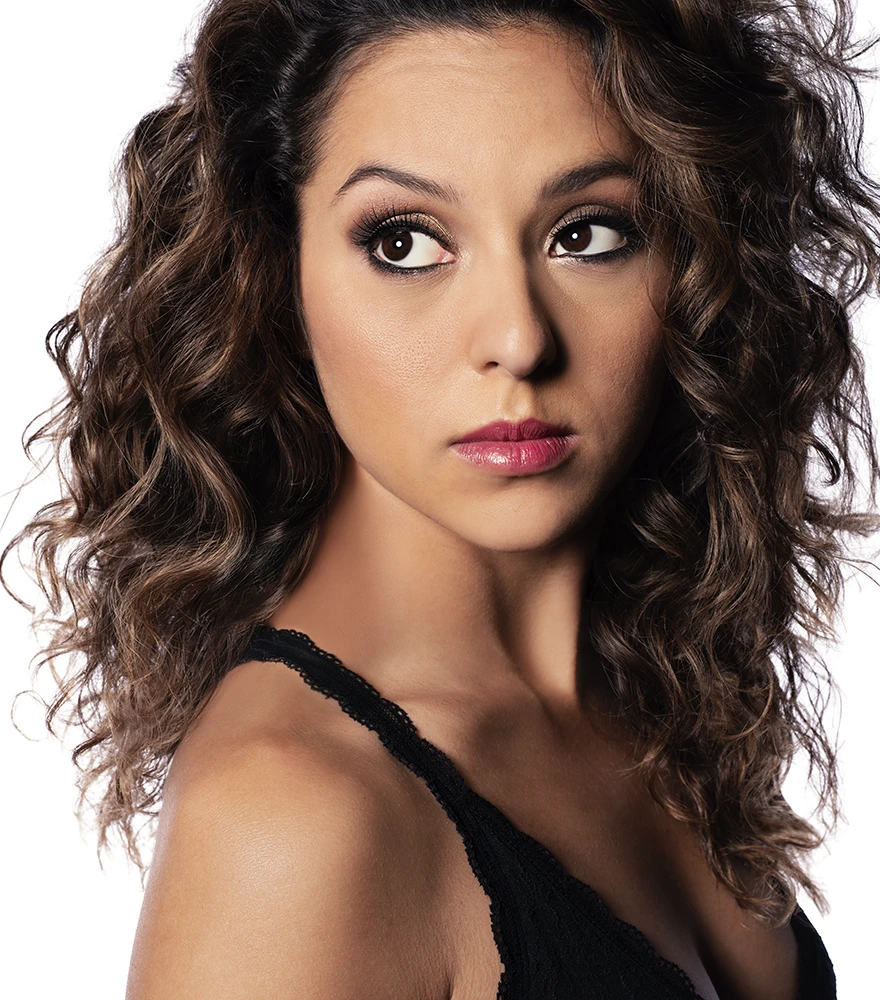 Glamorous beauty retouch of female portrait with enhanced skin, eyes, and lighting.