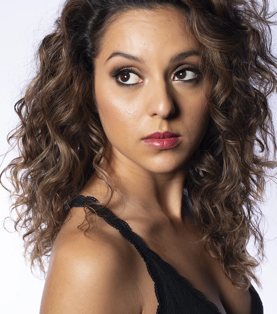 Original female portrait with minor skin texture and less vibrant lighting.