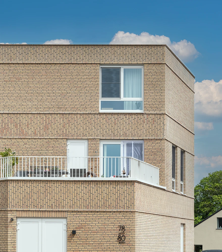Residential building with vibrant blue sky and soft white clouds.