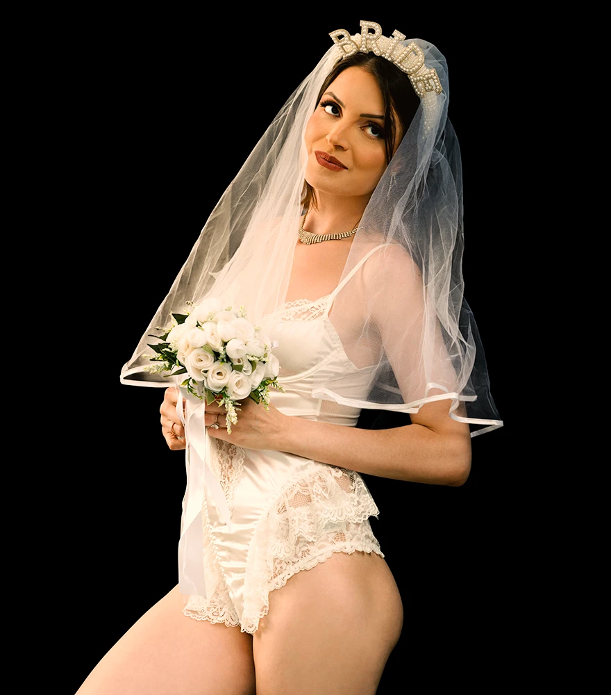 Bride in lingerie and veil on a black background with enhanced skin tone and details.